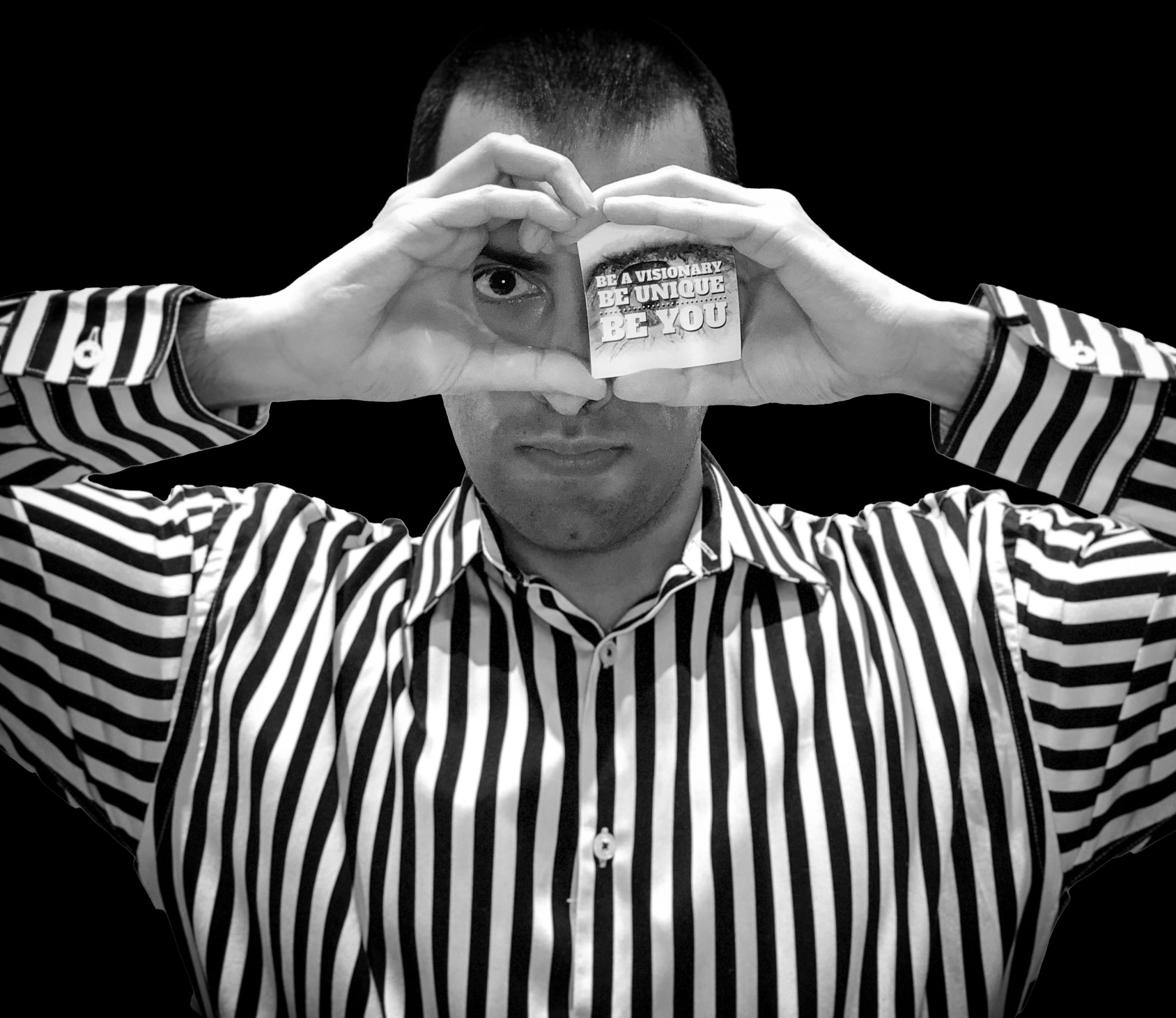 Eye gazing with motivational words and a positive message, whilst wearing a stylish black and white striped shirt