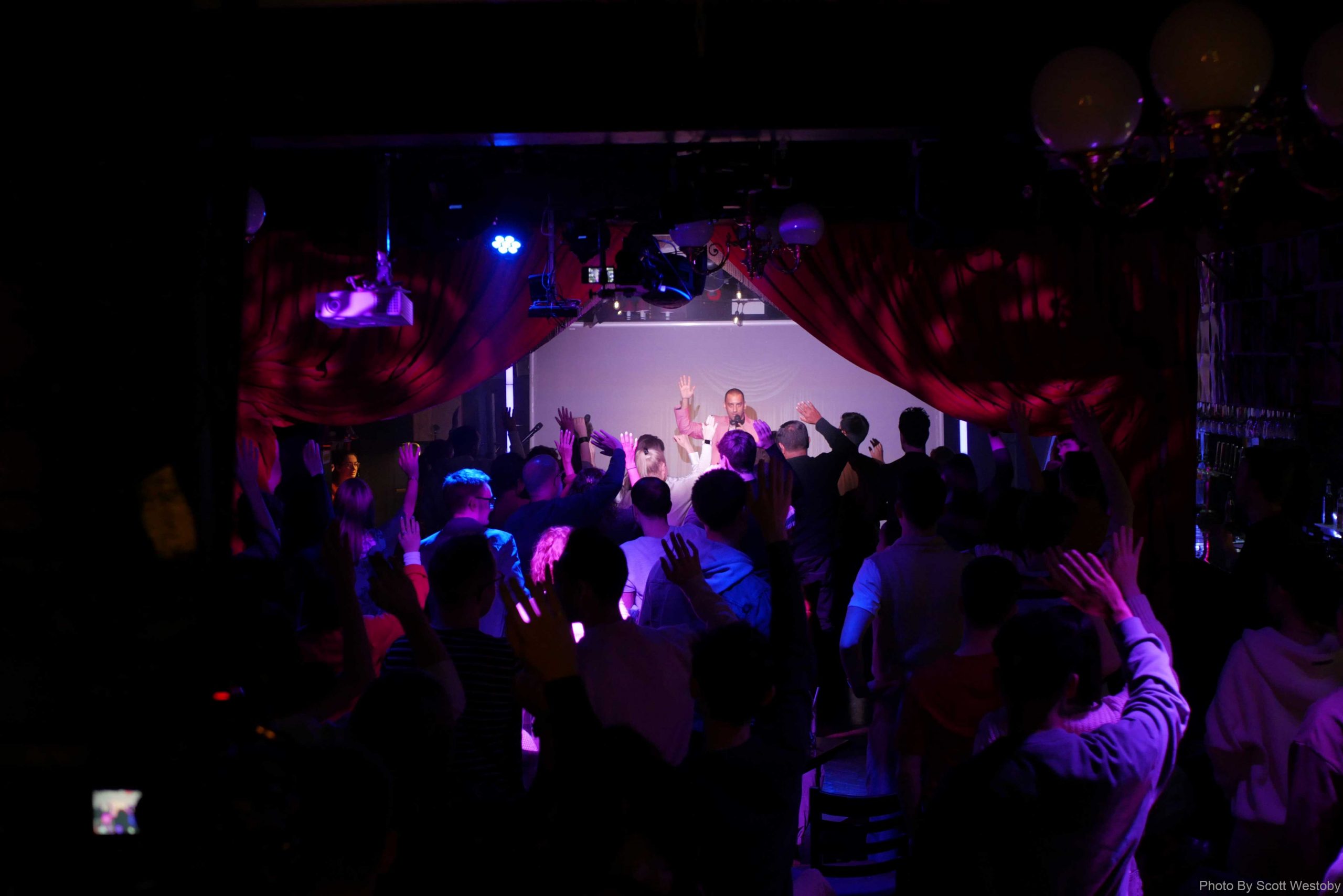 Audience raising their hands during this entertainment cabaret show in London's West End