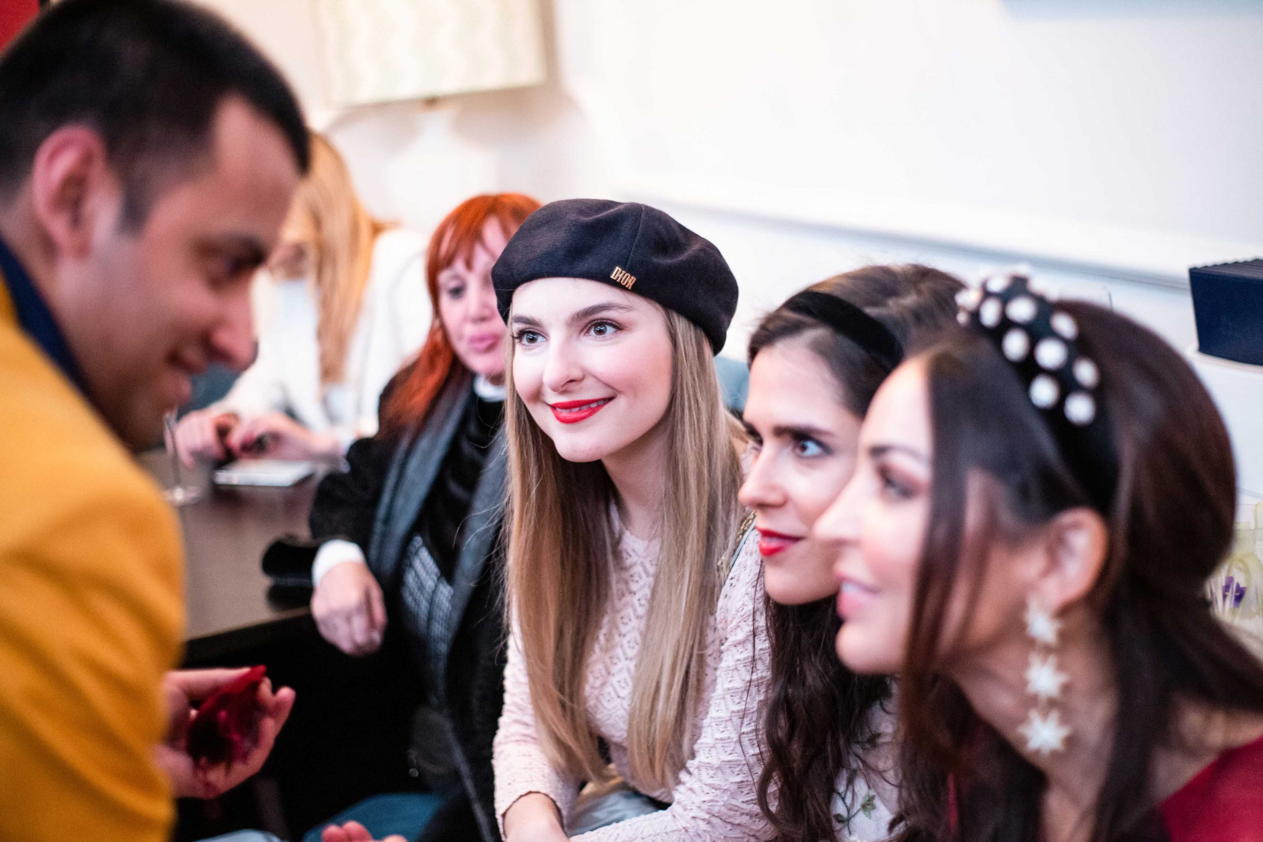 Entertainer smiling and laughing with VIP guests at red carpet event